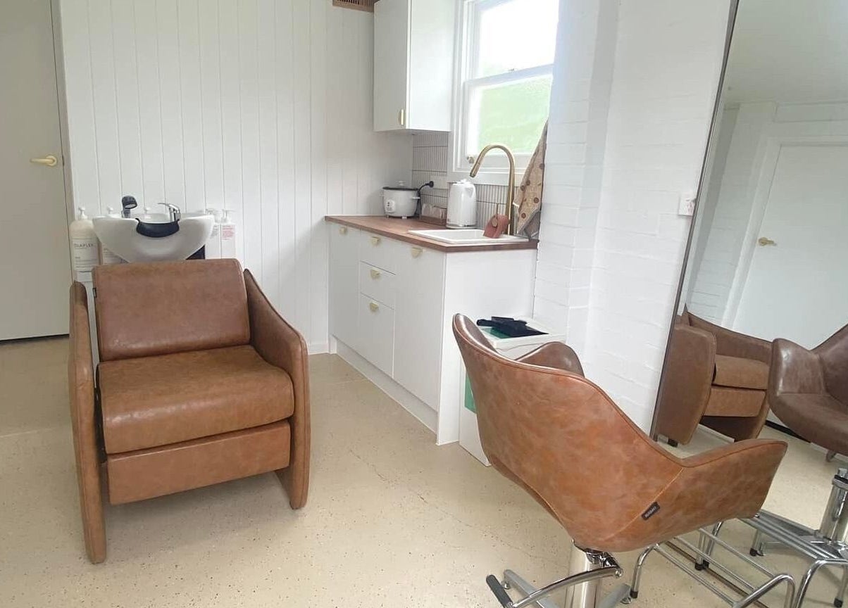 Elegant salon chair and mirror at Prosper Studio, Belmont, Victoria, AU featuring modern decor.