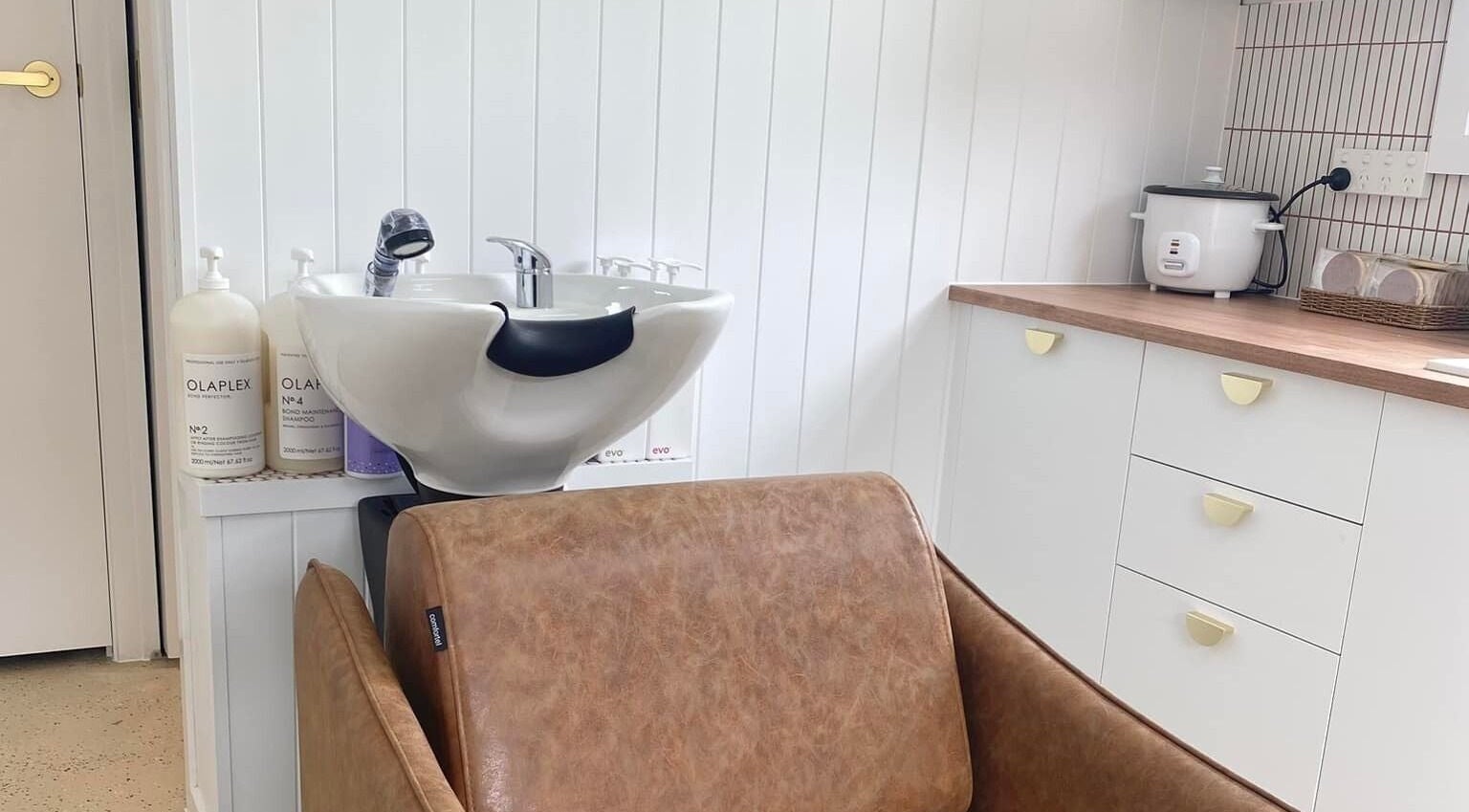 Elegant salon wash station at Prosper Studio, Belmont, Victoria, AU, featuring premium products and sleek design.