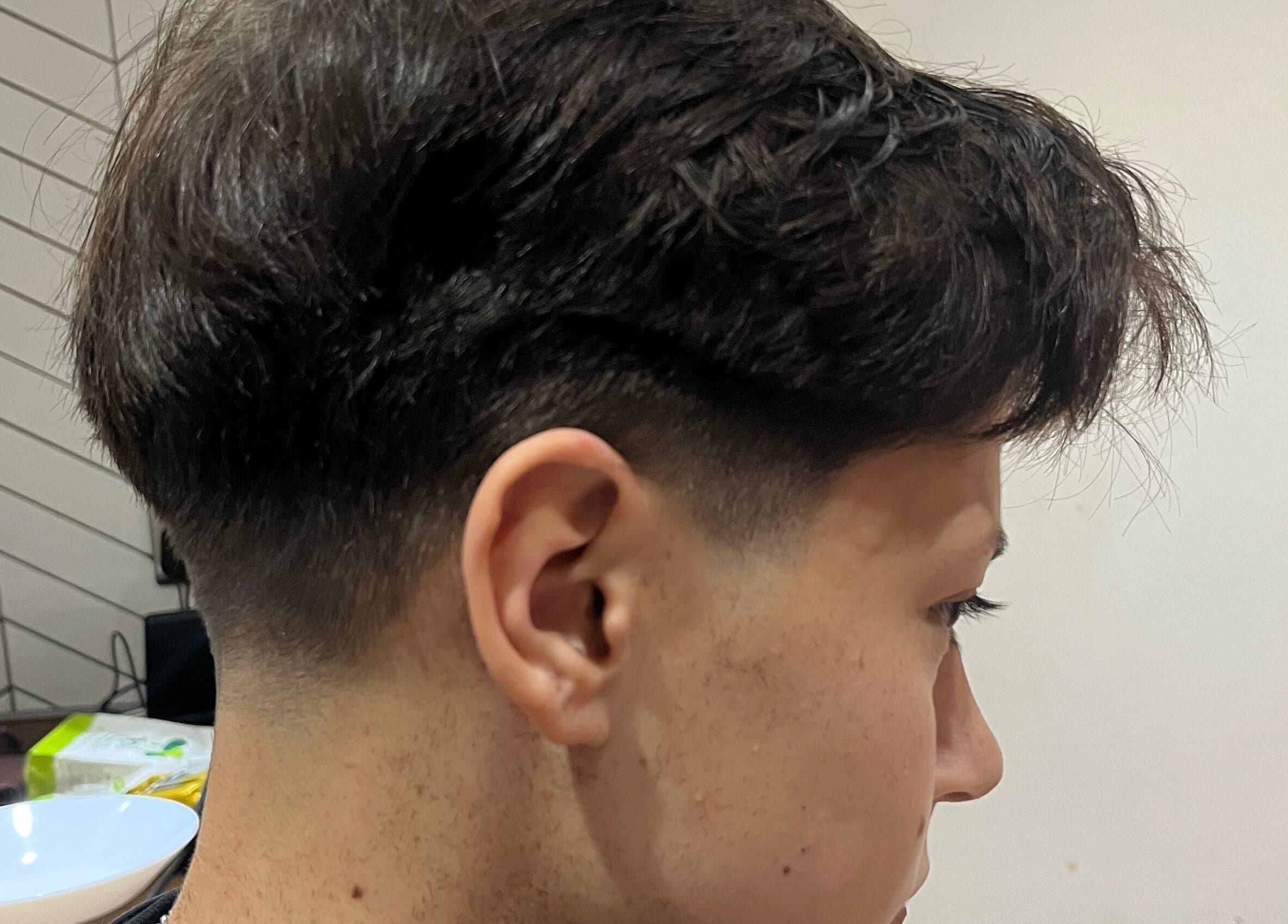 Freshly styled haircut at Delzcutz, Gravesend, England, GB. Side view shows sharp lines and textured top.