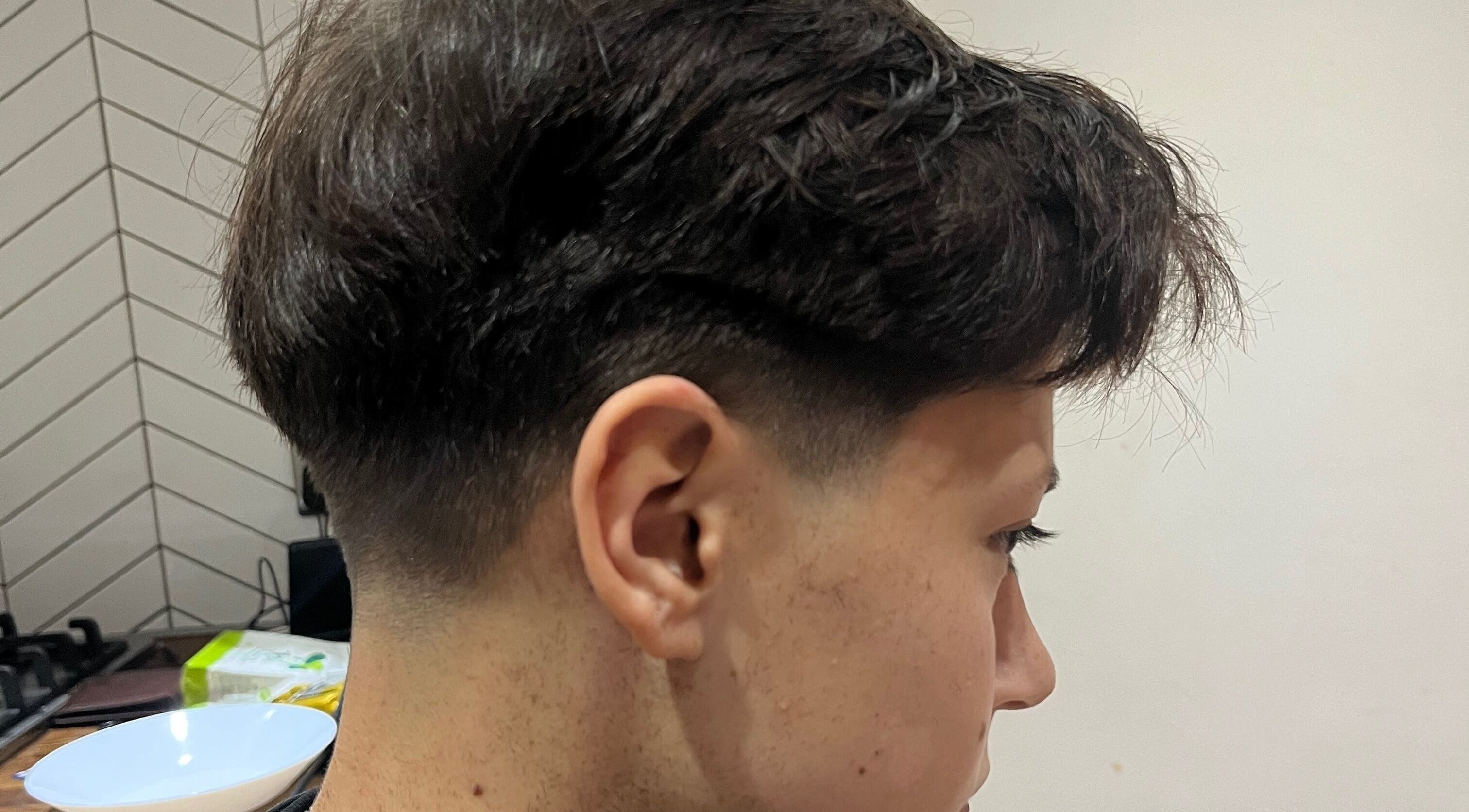 Freshly styled haircut at Delzcutz, Gravesend, England, GB. Side view shows sharp lines and textured top.