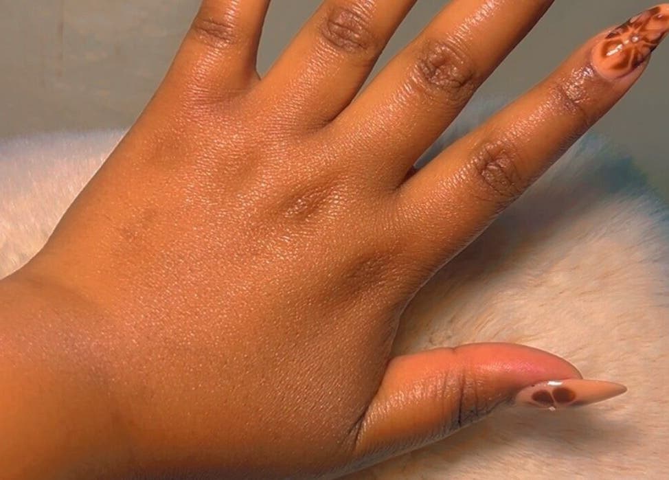 Stylish nail design at CANDIA BEAUTY, Nairobi, Nairobi County, KE. Hand shows intricate nail art.