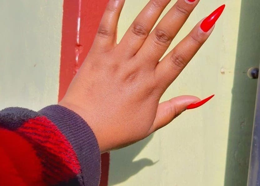 Vibrant red nail art detail at CANDIA BEAUTY, Nairobi, Nairobi County, KE showcasing stunning hand design.