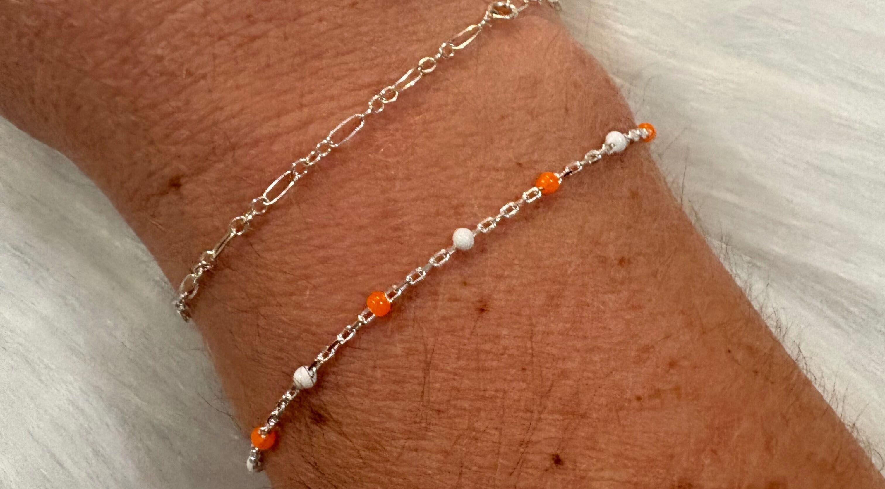 Layered & Linked bracelets showcase intricate silver and orange design in Madisonville, Tennessee, US.