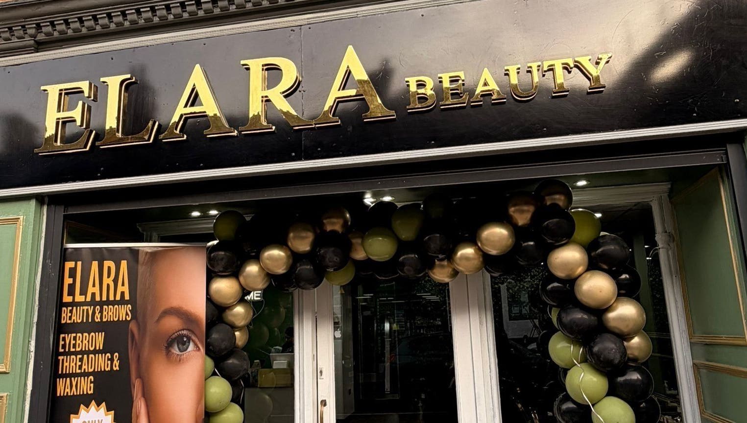 Front of ELARA BEAUTY in Tranent, Scotland with festive balloon arch and signage.