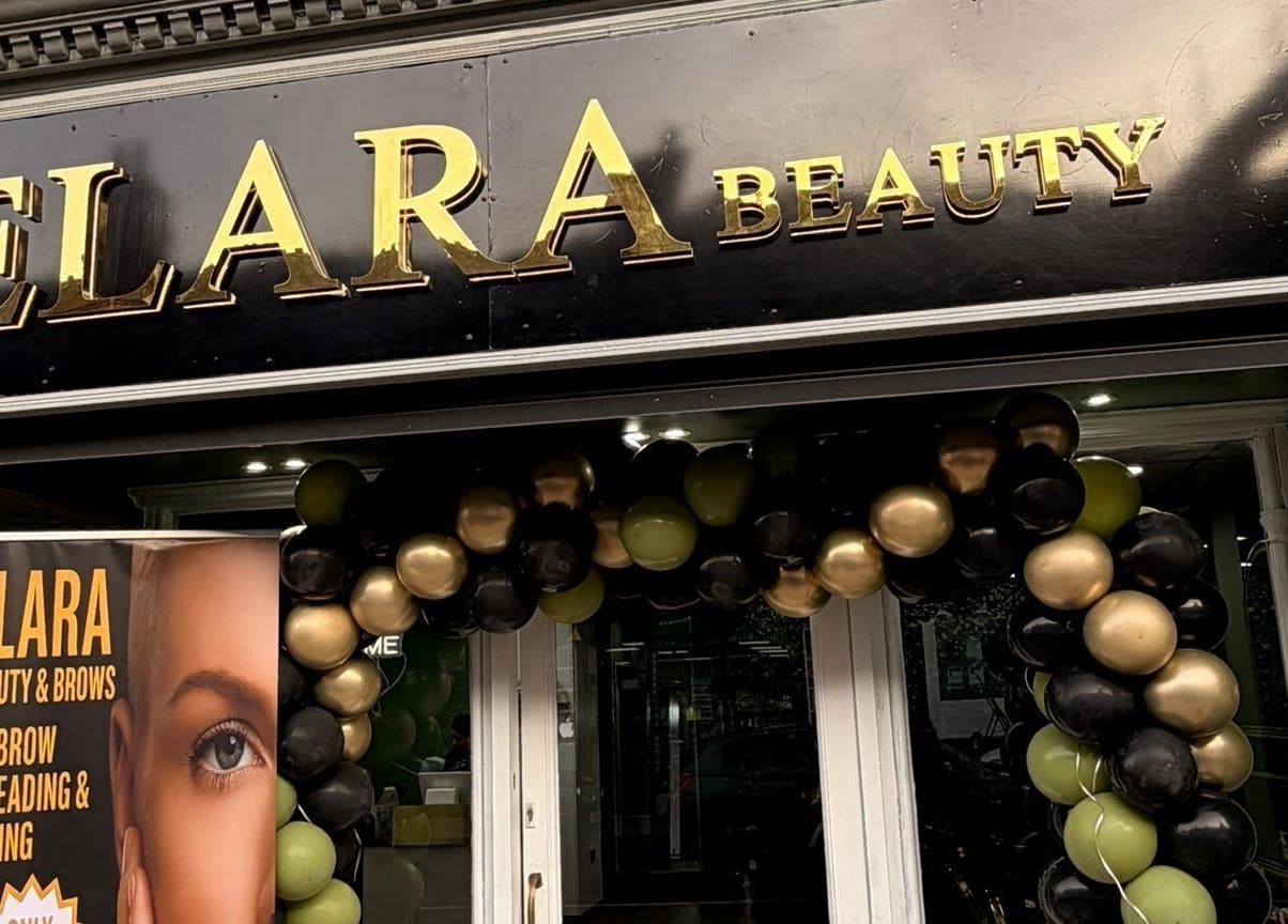 Front of ELARA BEAUTY in Tranent, Scotland with festive balloon arch and signage.