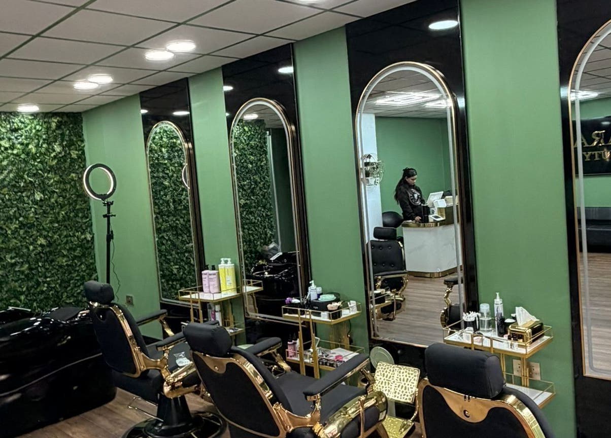 Modern salon interior at ELARA BEAUTY, Tranent, Scotland, GB, with stylish chairs and green decor.