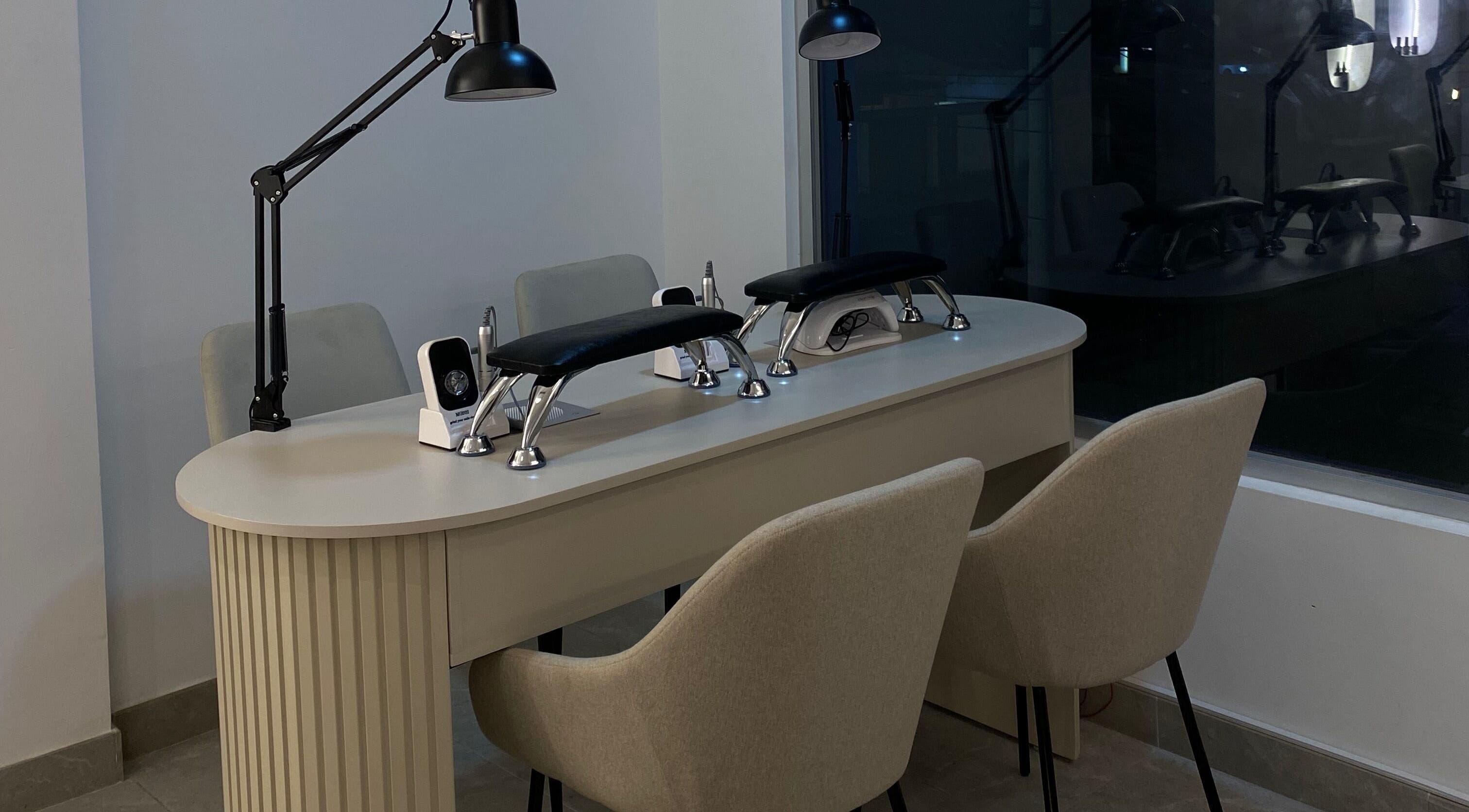 Mesa de manicura en Orena Self Care Club, Guayaquil, Guayas, EC, con sillas cómodas y luz suave.