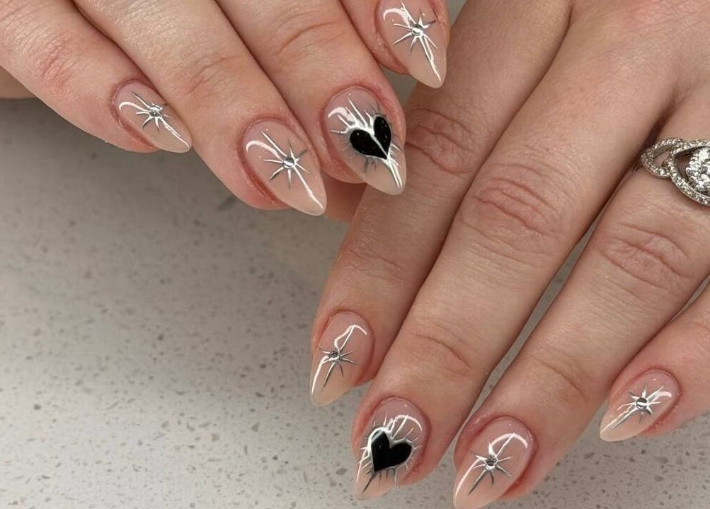 Elegant nail art at Hadis Nail, Sydney, New South Wales, AU showcases chic heart and star designs.