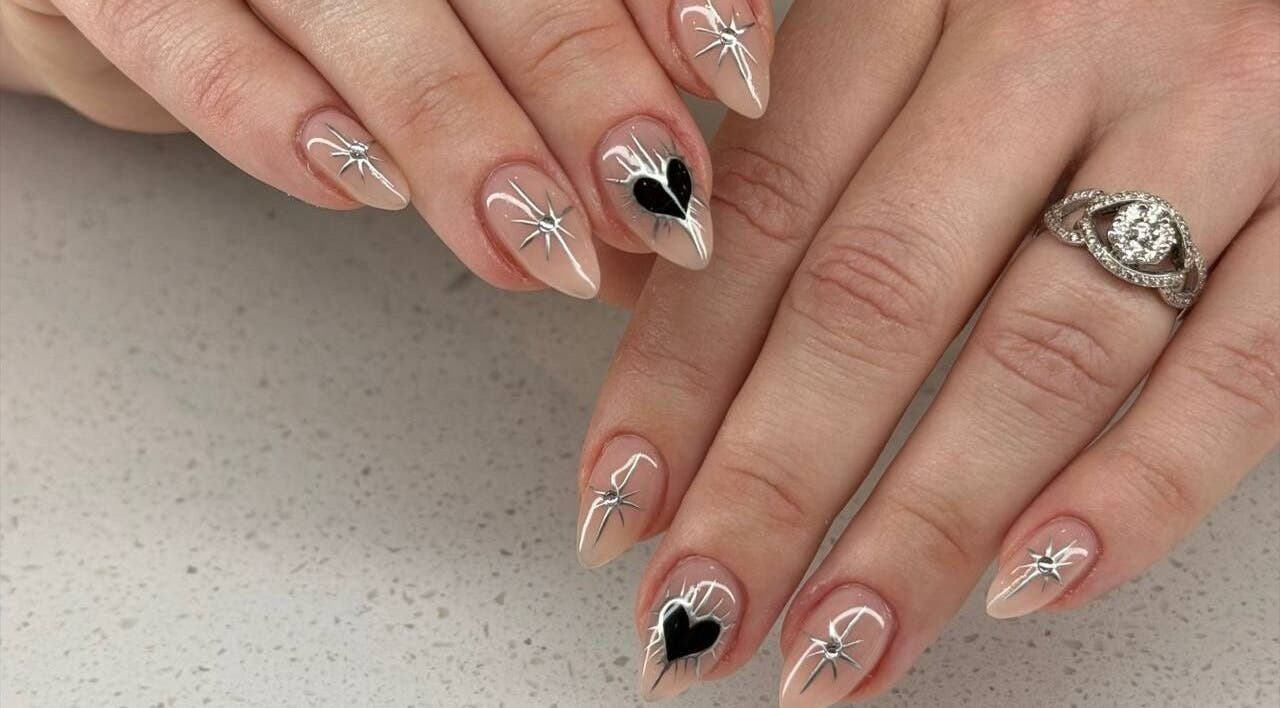 Elegant nail art at Hadis Nail, Sydney, New South Wales, AU showcases chic heart and star designs.