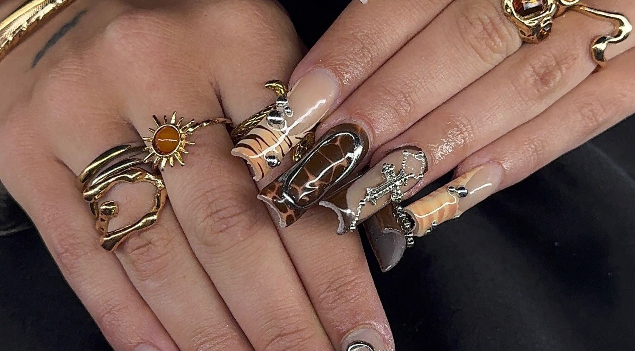 Intricate nail art and gold rings at Prettynpolished, Bell Post Hill, Victoria, AU showcasing luxurious style.