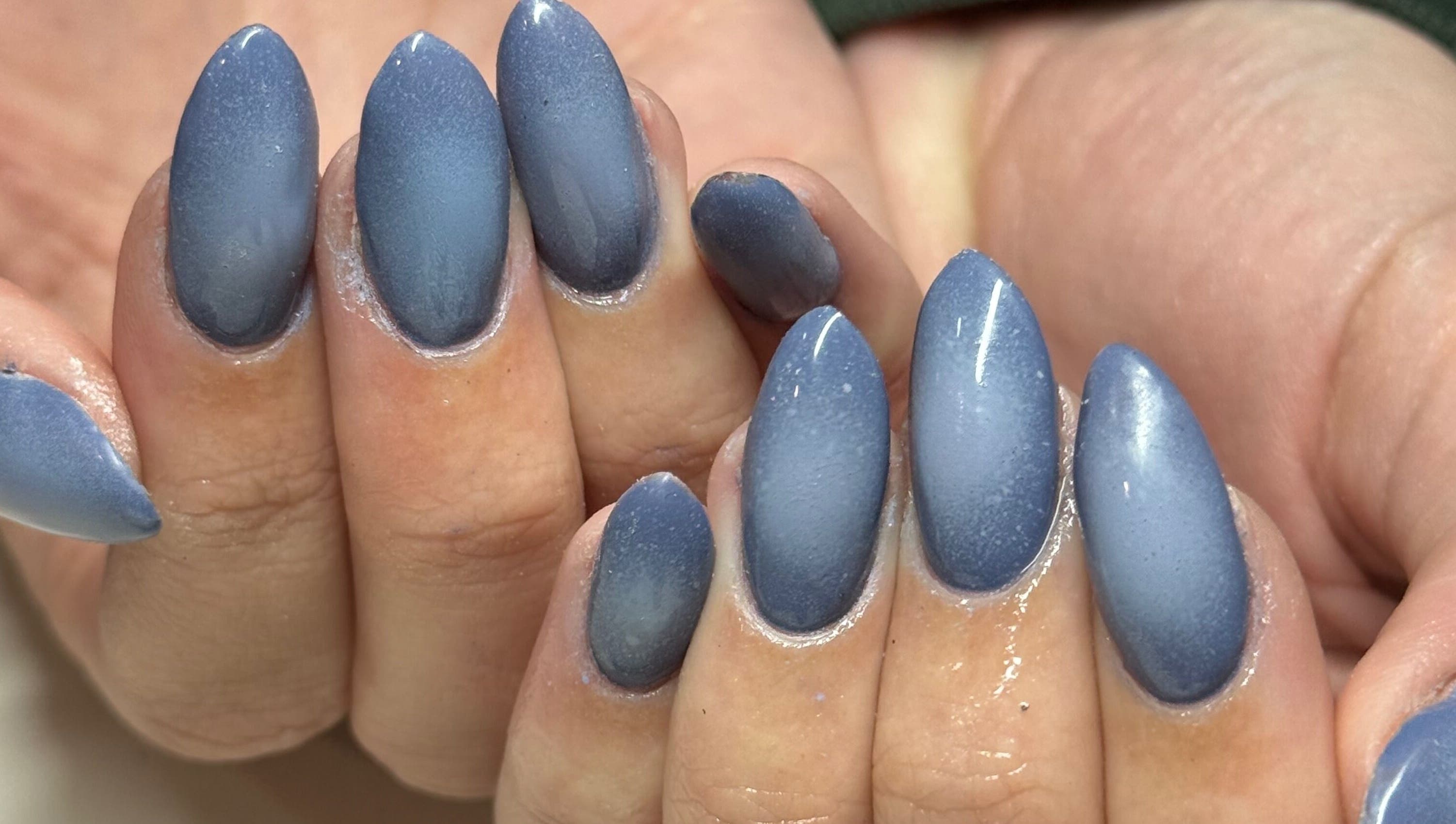 Close-up of elegant indigo nails at Curedbykais, Logan, Utah, US, showcasing expert manicure finishing.