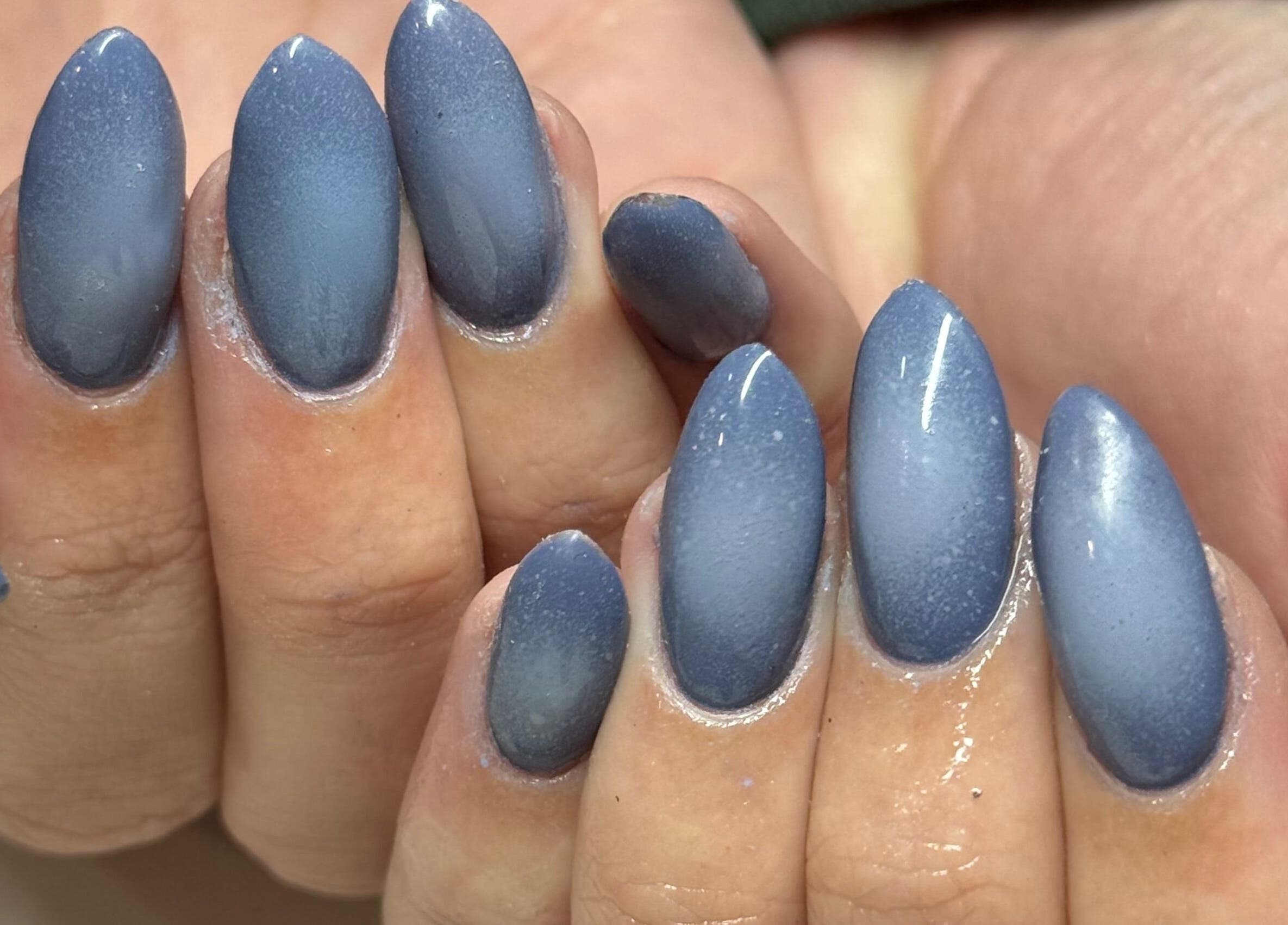 Close-up of elegant indigo nails at Curedbykais, Logan, Utah, US, showcasing expert manicure finishing.