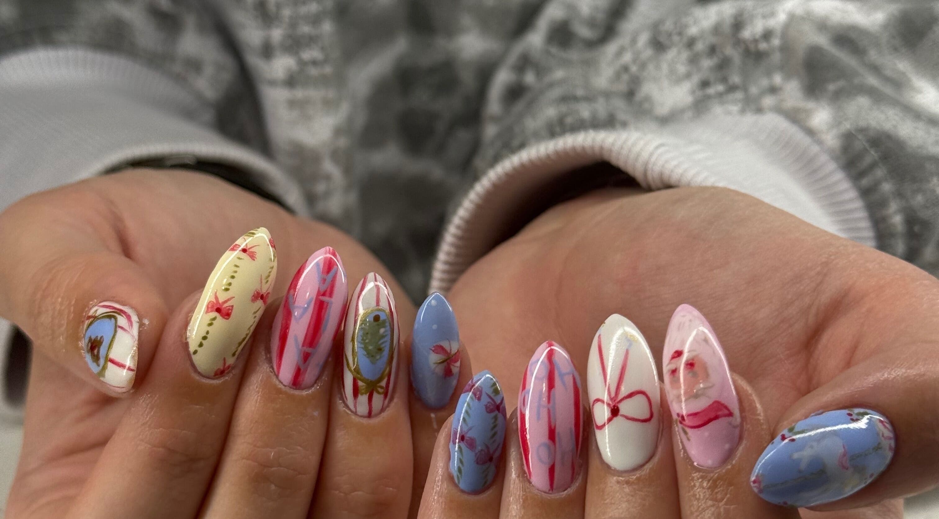 Close-up of vibrant, artistic nails at Curedbykais, Logan, Utah, US showcasing intricate designs.