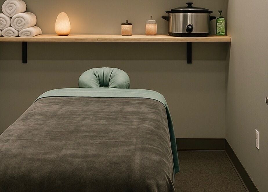 Calming massage room at Aura Eleven Massage, Stafford Township, New Jersey, US, featuring a cozy bed and ambient lighting.