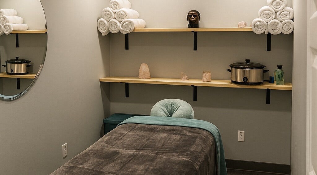 Cozy massage room at Aura Eleven Massage, Stafford Township, New Jersey with neatly arranged towels and tranquil decor.