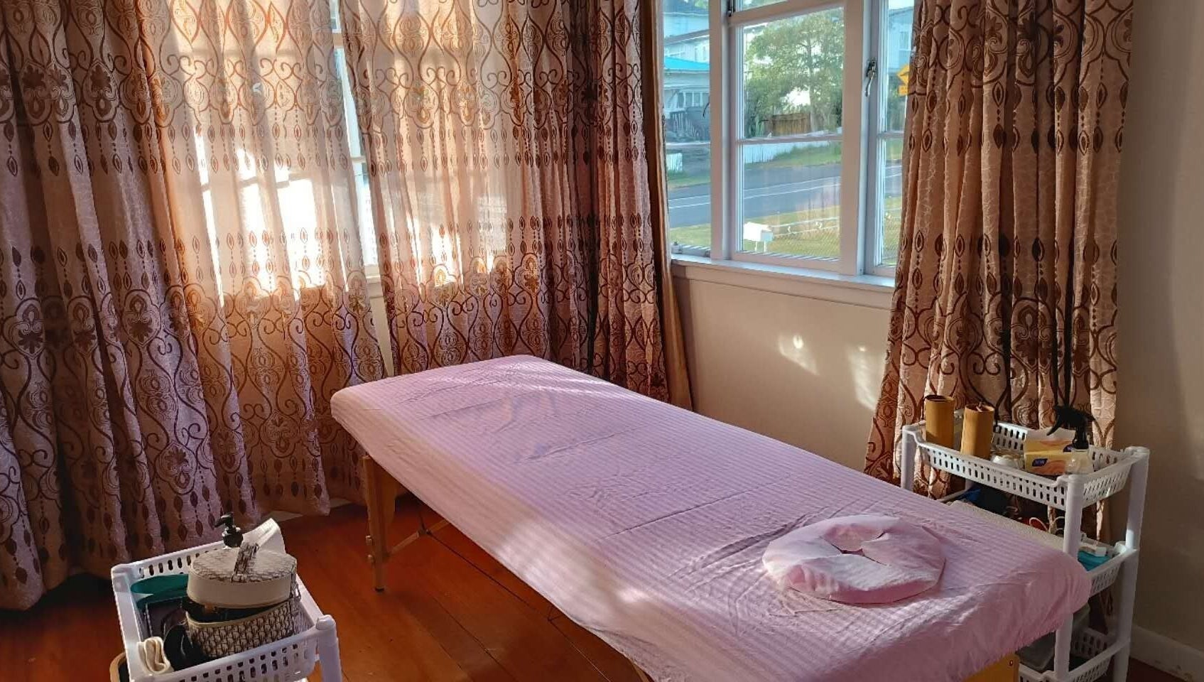 Cozy massage room at Harmony River - Home Studio (Sandringham), Auckland, NZ with soft pink decor.