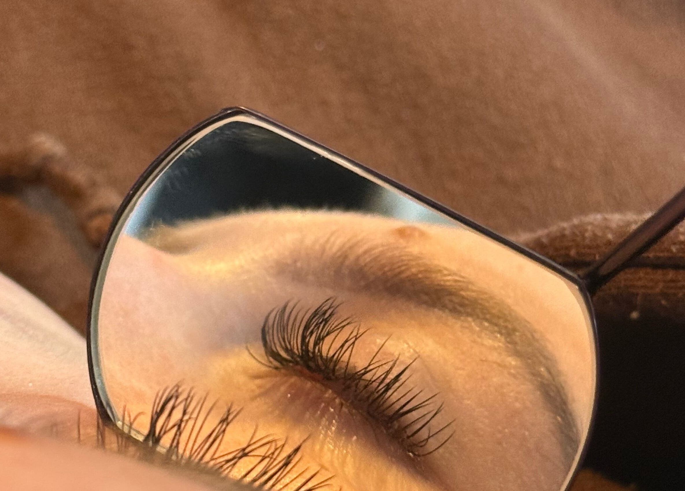 Close-up of meticulously applied eyelashes at MPLashes, Southport, England, GB, reflecting in a small mirror.