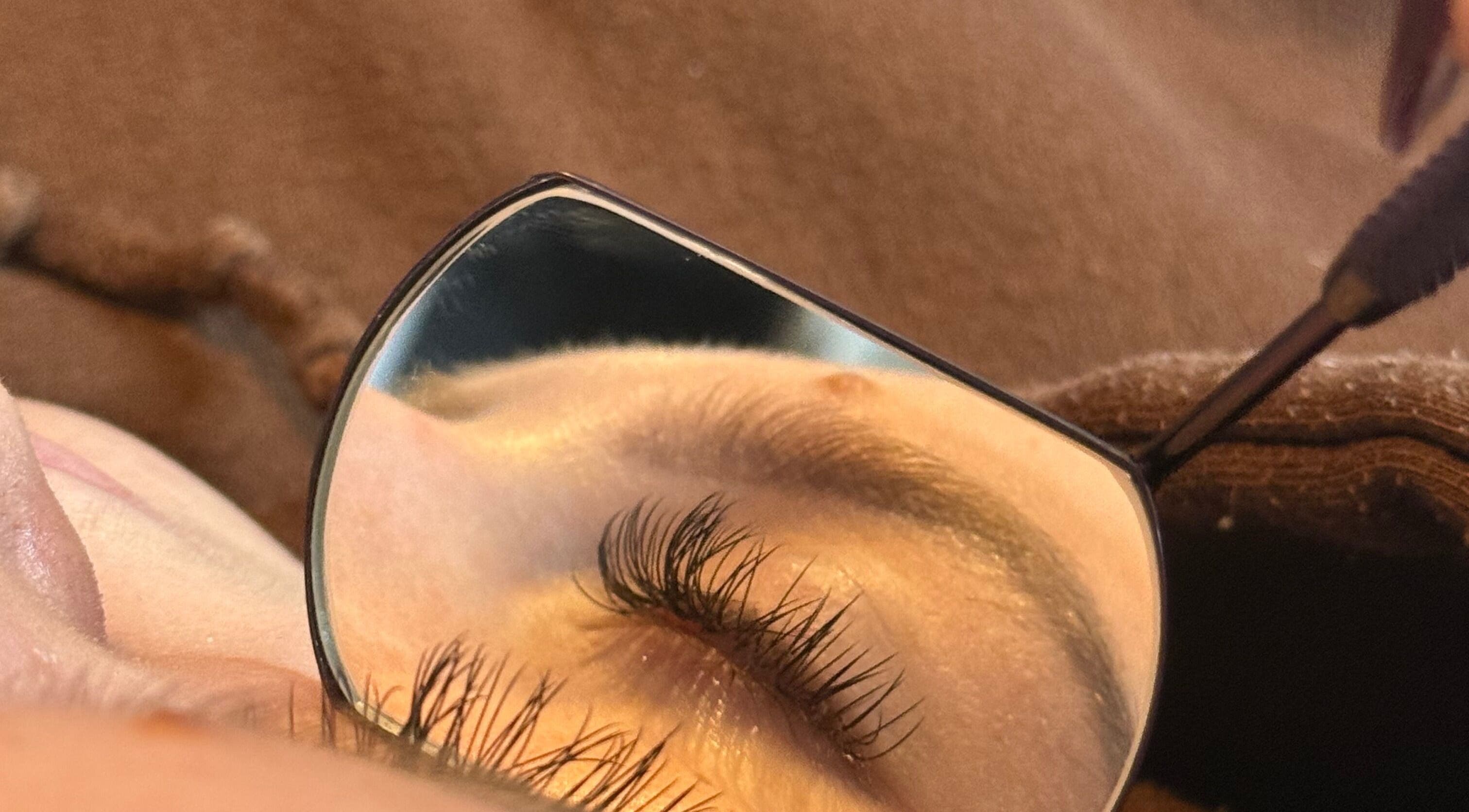 Close-up of meticulously applied eyelashes at MPLashes, Southport, England, GB, reflecting in a small mirror.