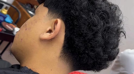 Close-up of a haircut at Street Barber Shop in Kota Kinabalu, Sabah, MY, showcasing textured curls.