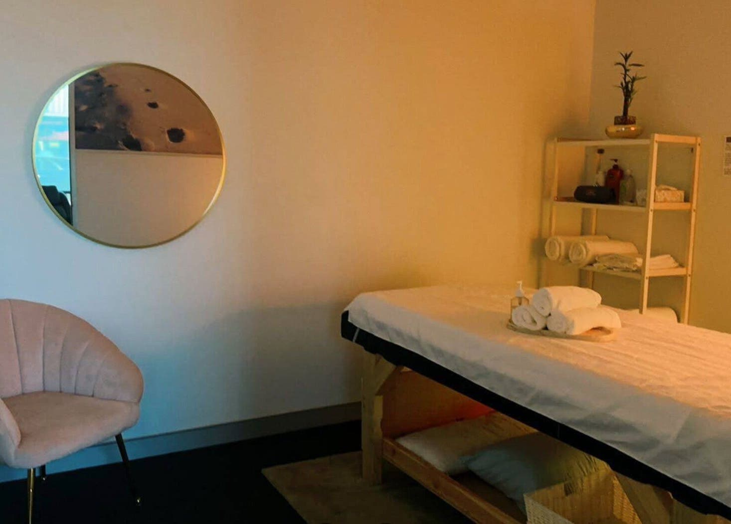 Relaxing massage room at Fern Massage and Beauty in Perth, Western Australia, AU with a comfy chair and mirror.