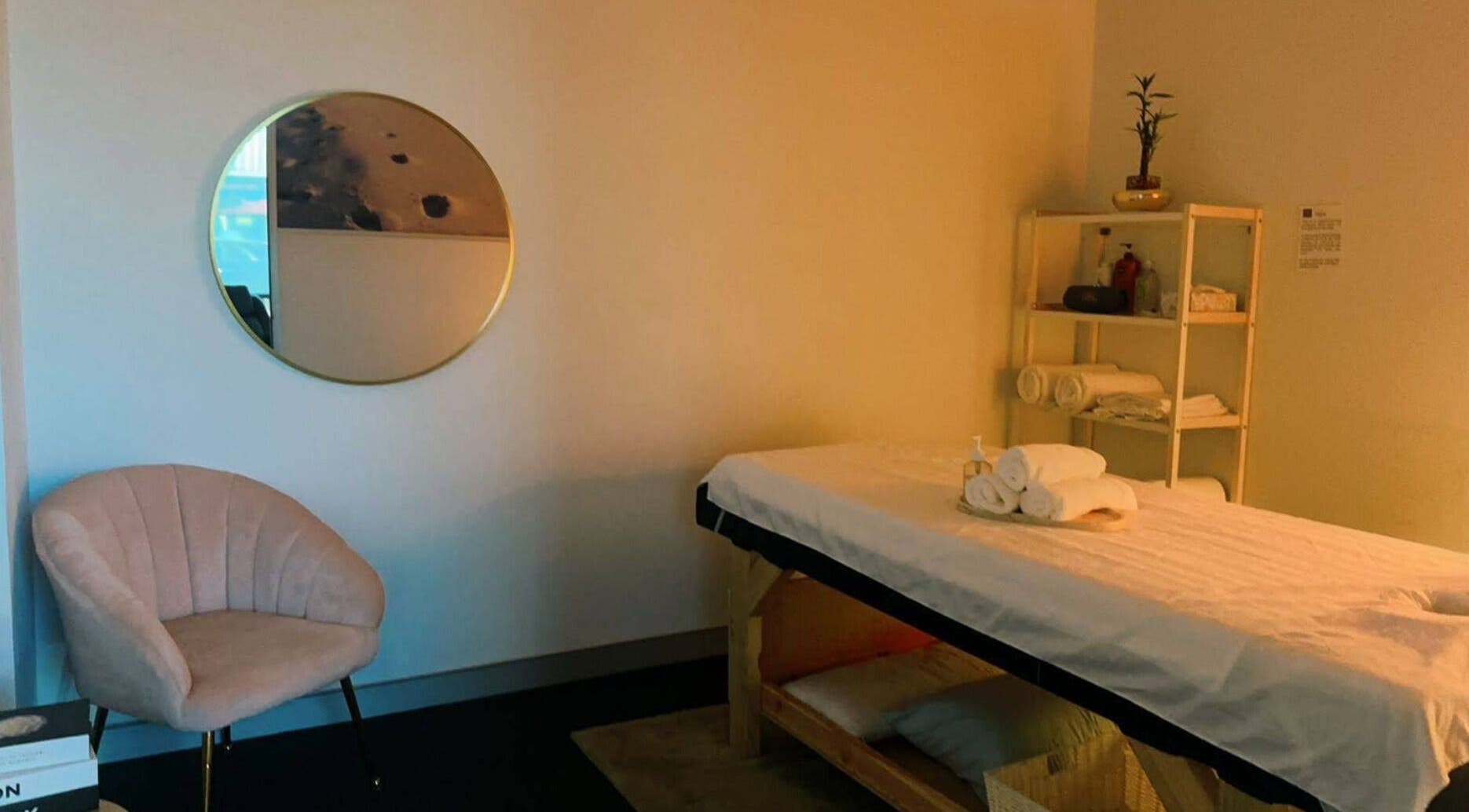 Relaxing massage room at Fern Massage and Beauty in Perth, Western Australia, AU with a comfy chair and mirror.