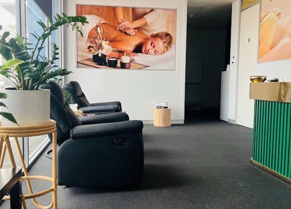 Relaxing lounge area at Fern Massage and Beauty, Perth, Western Australia, AU, with comfy chairs and plants.