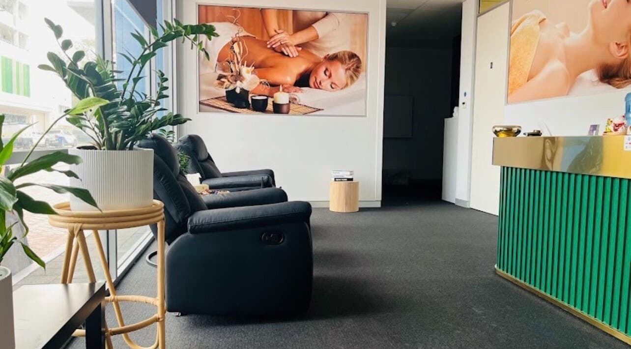 Relaxing lounge area at Fern Massage and Beauty, Perth, Western Australia, AU, with comfy chairs and plants.