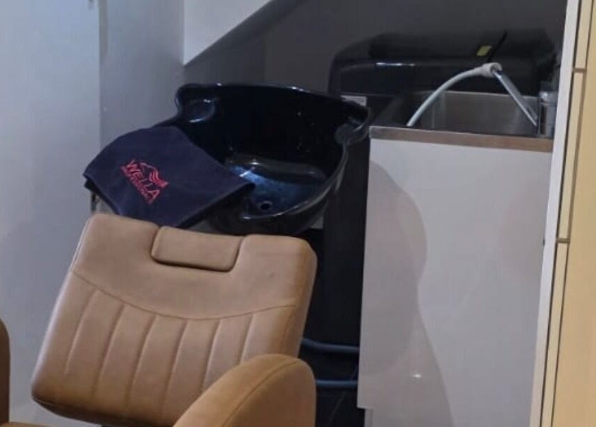 Comfortable wash station at Jocelyn Hair Xo in Melbourne, AU, featuring a leather chair and modern basin.