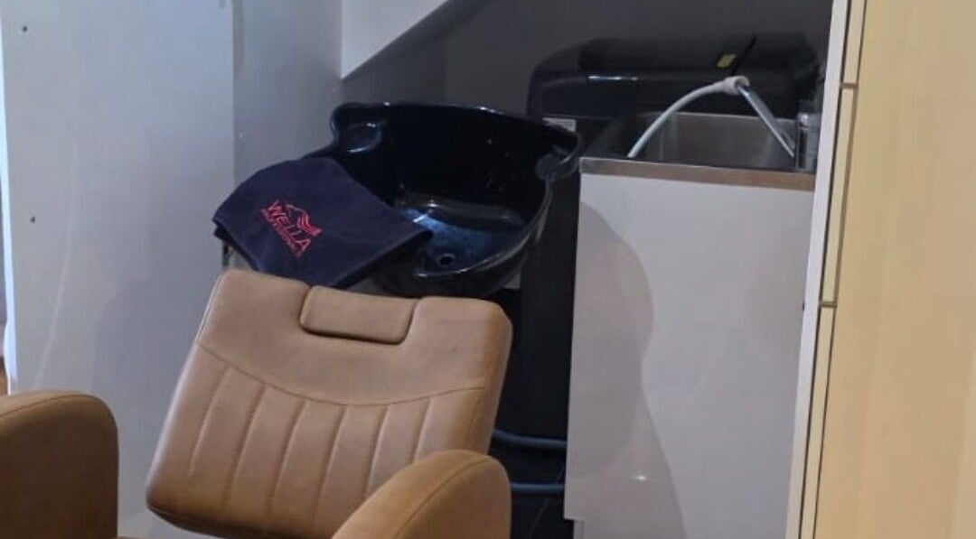 Comfortable wash station at Jocelyn Hair Xo in Melbourne, AU, featuring a leather chair and modern basin.