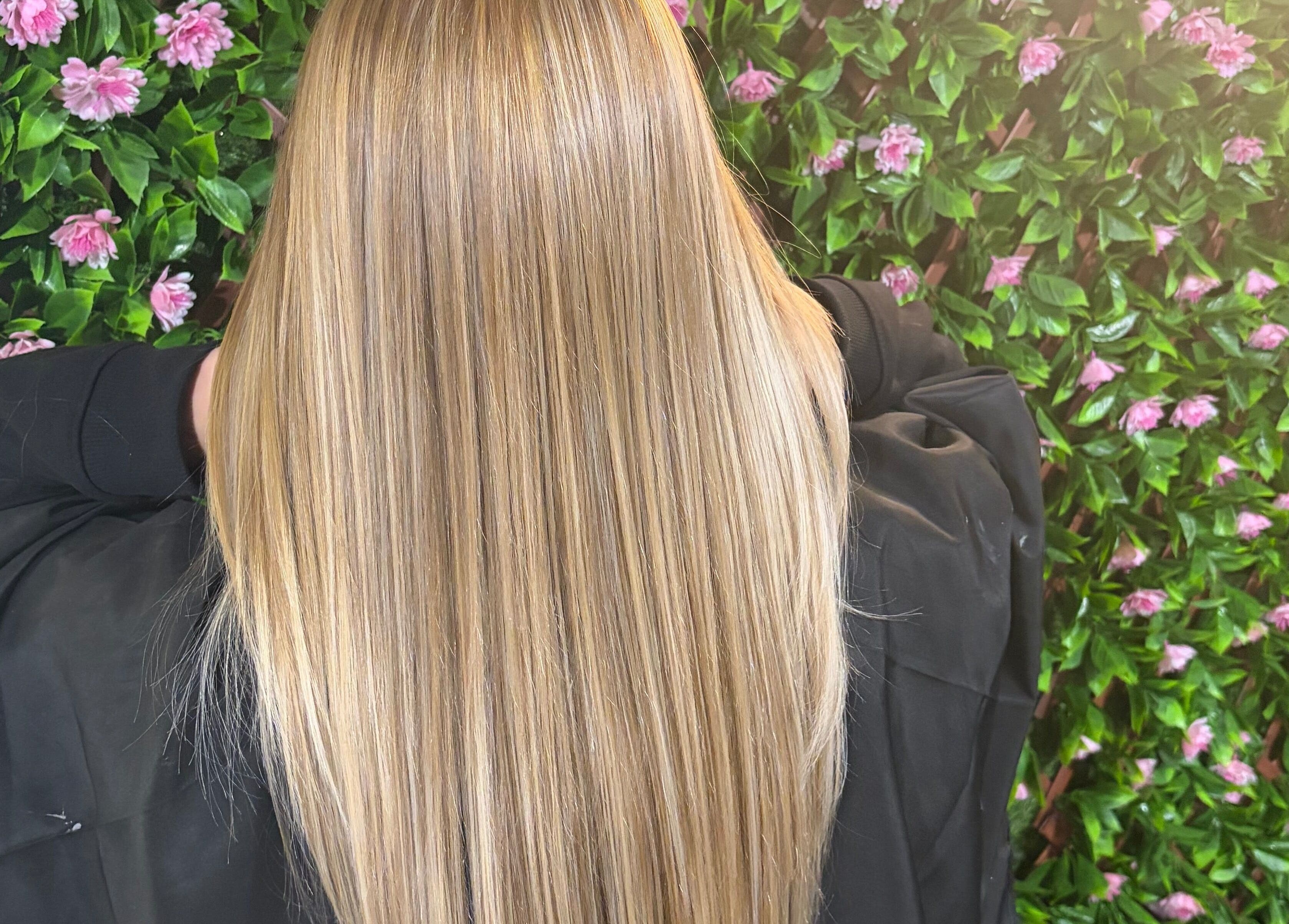 Sleek blonde hair against a floral wall at 133 by el ltd, Dewsbury, England, GB.