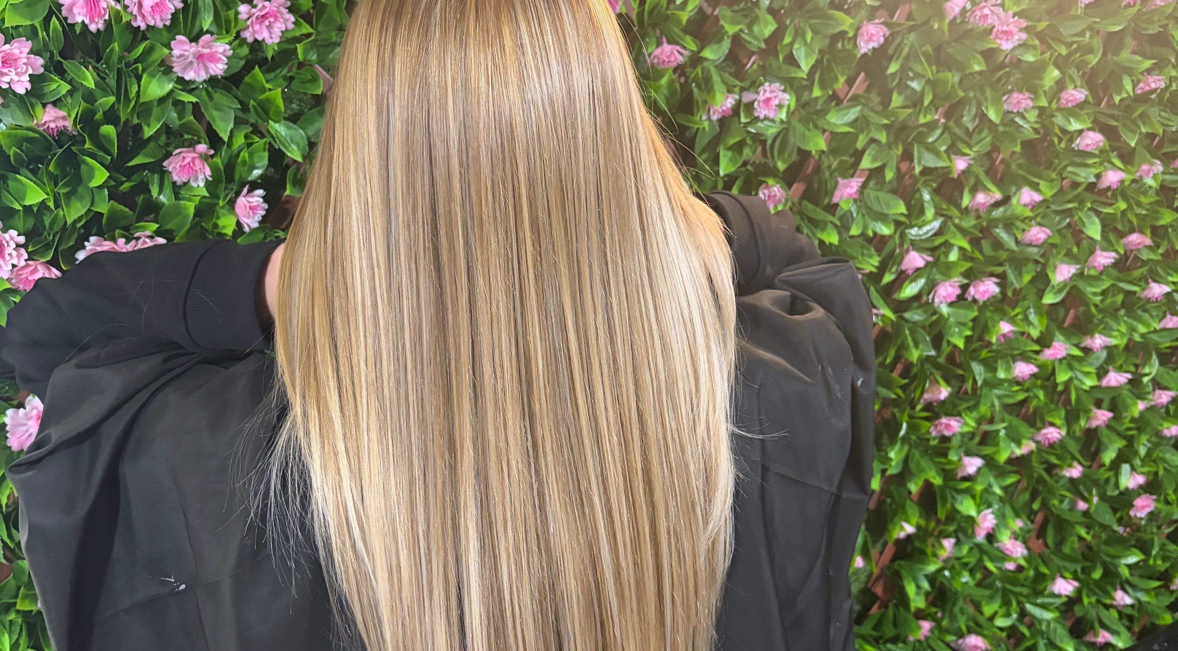 Sleek blonde hair against a floral wall at 133 by el ltd, Dewsbury, England, GB.