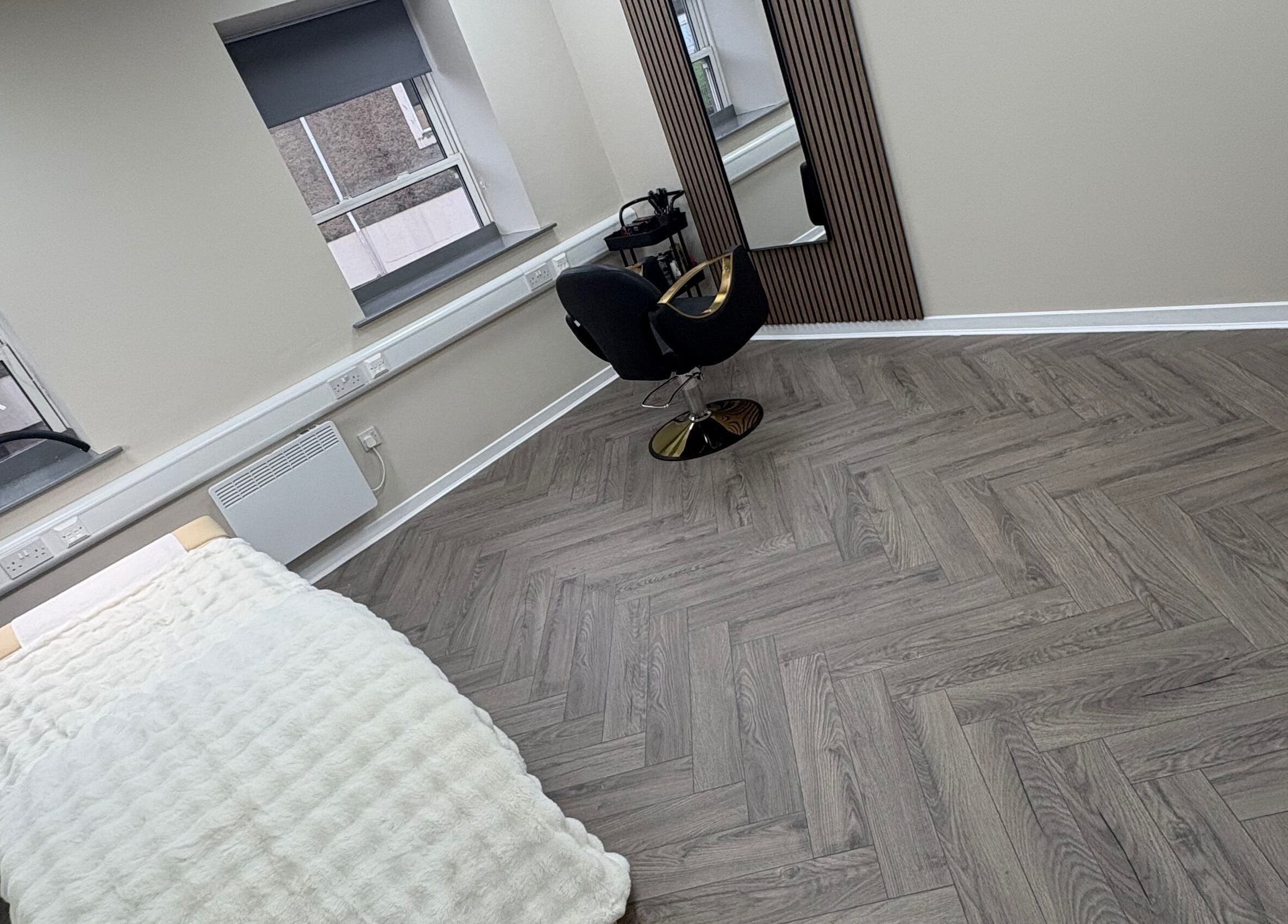 Tranquil beauty room at Abuela, featuring a plush bed and stylish chair, in Kilmarnock, Scotland, GB.