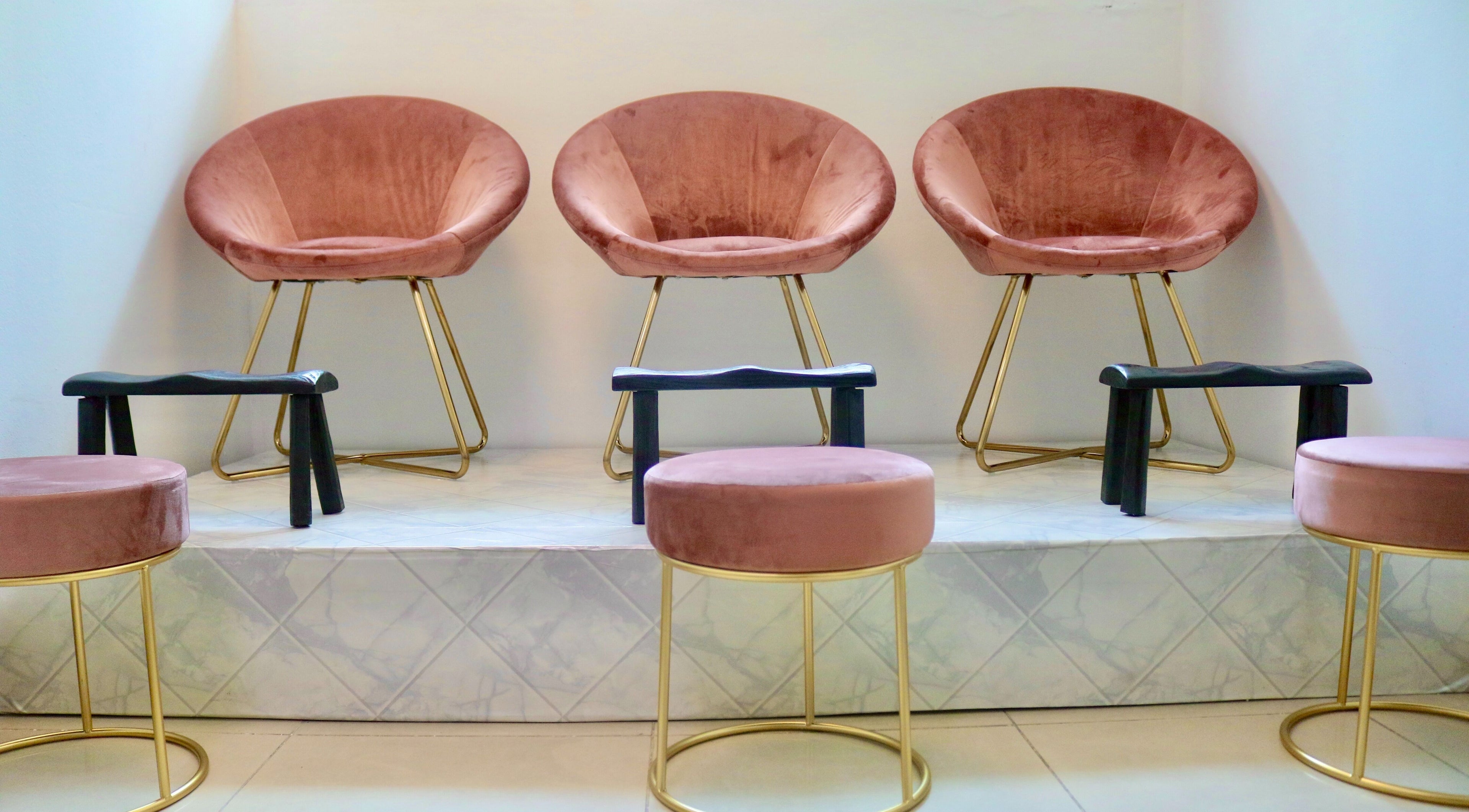Luxurious pink velvet chairs at Arolè Beauty, Gaborone, BW, offering comfort and style.