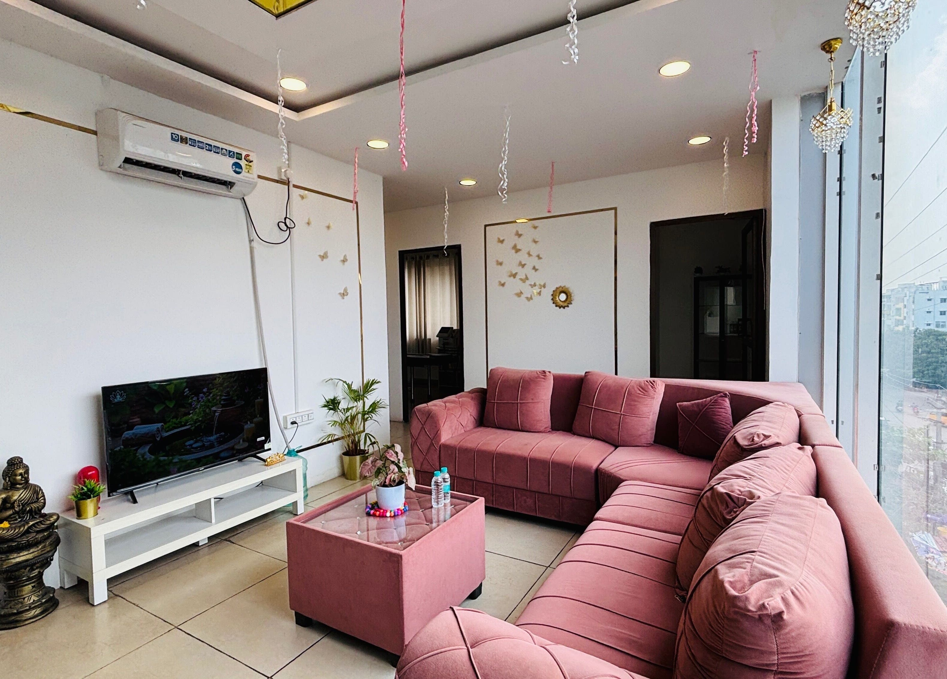 Chic lounge at Dr. Akhilas Aesthetics, Hyderabad, Telangana, IN with plush pink seating and modern decor.