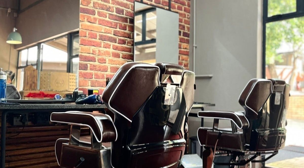 Classic barber chairs at Buffelsfontein Barbier Menlo Park in Pretoria, Gauteng, ZA for a stylish grooming experience.