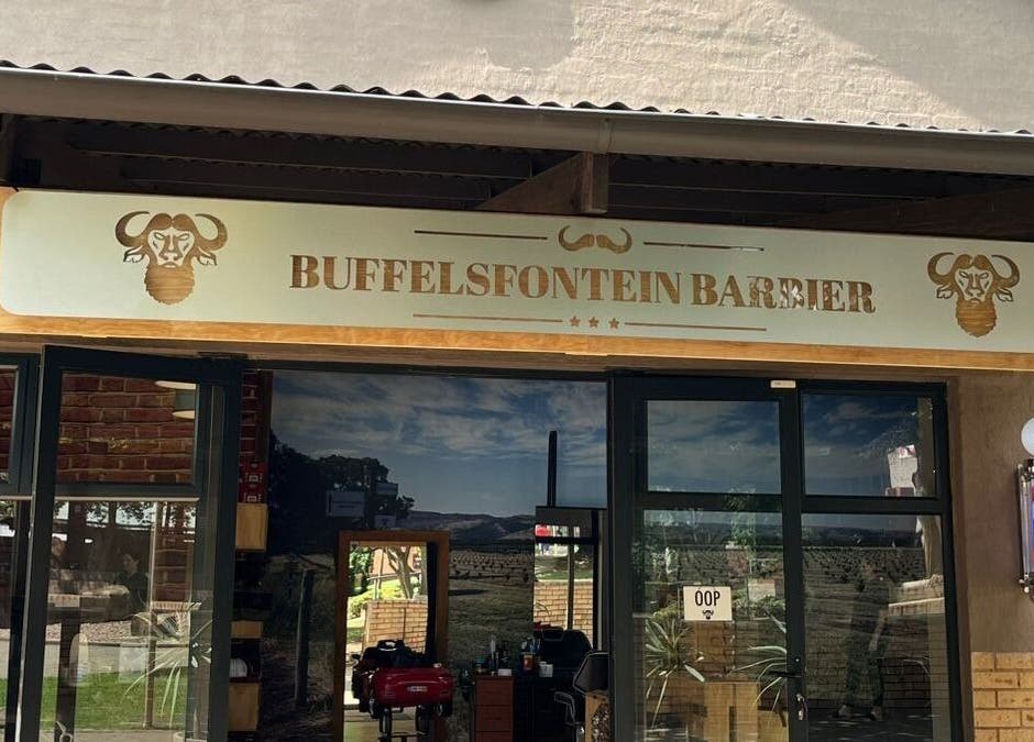 Entrance of Buffelsfontein Barbier Menlo Park, Pretoria, Gauteng, ZA, showcasing modern barber shop exterior.