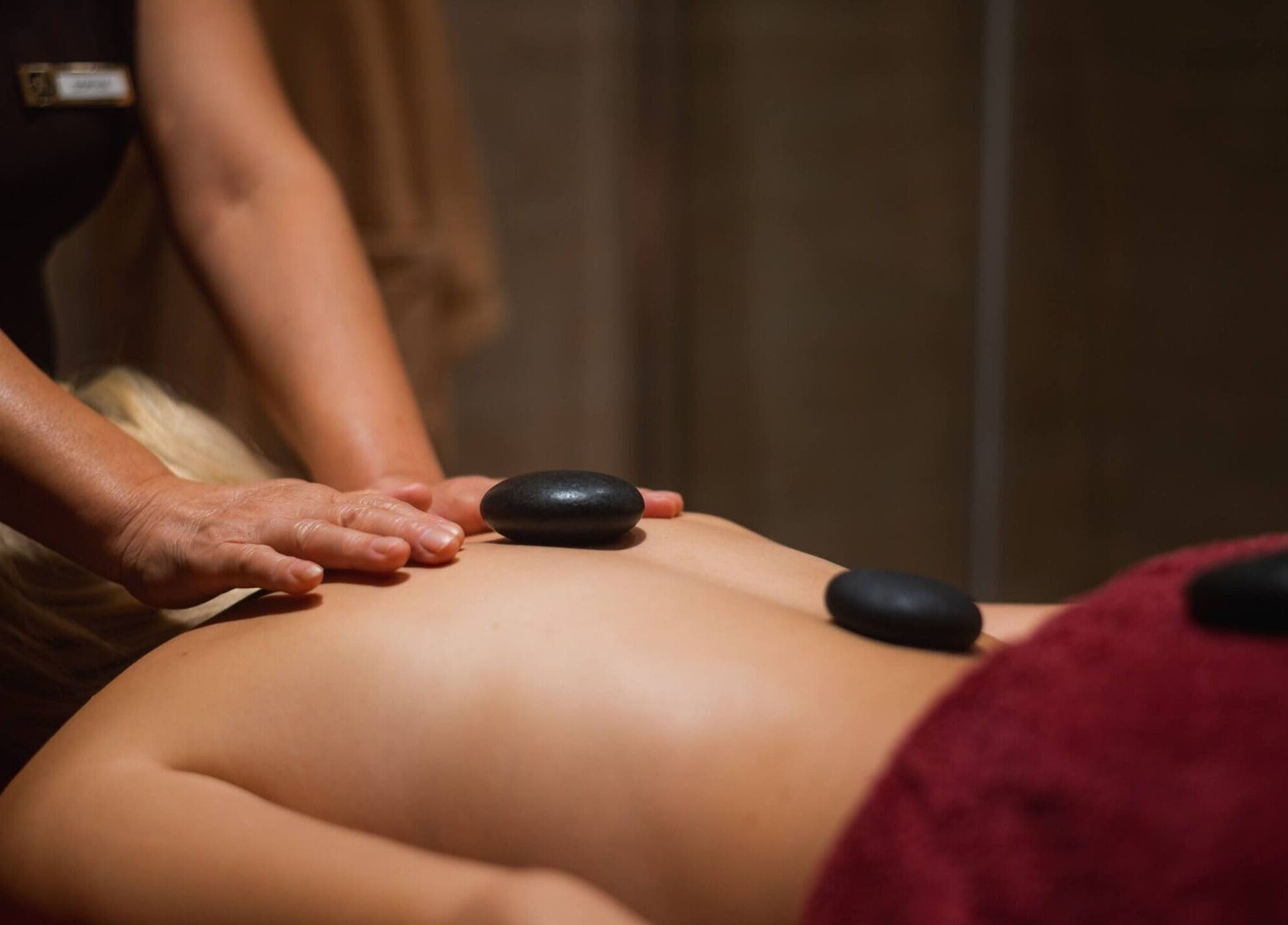 Luxurious hot stone massage at The Beauty Coven, Edinburgh, Scotland, GB. Relax in soothing ambiance.