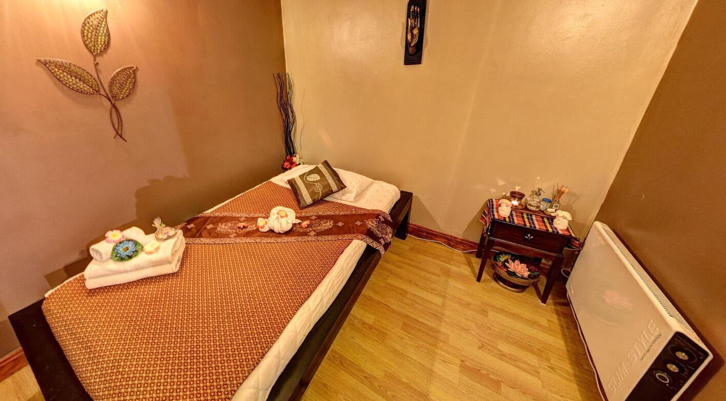 Tranquil massage room at Reanthai Massage and Spa, Andover, England, GB with a cozy bed and calming decor.