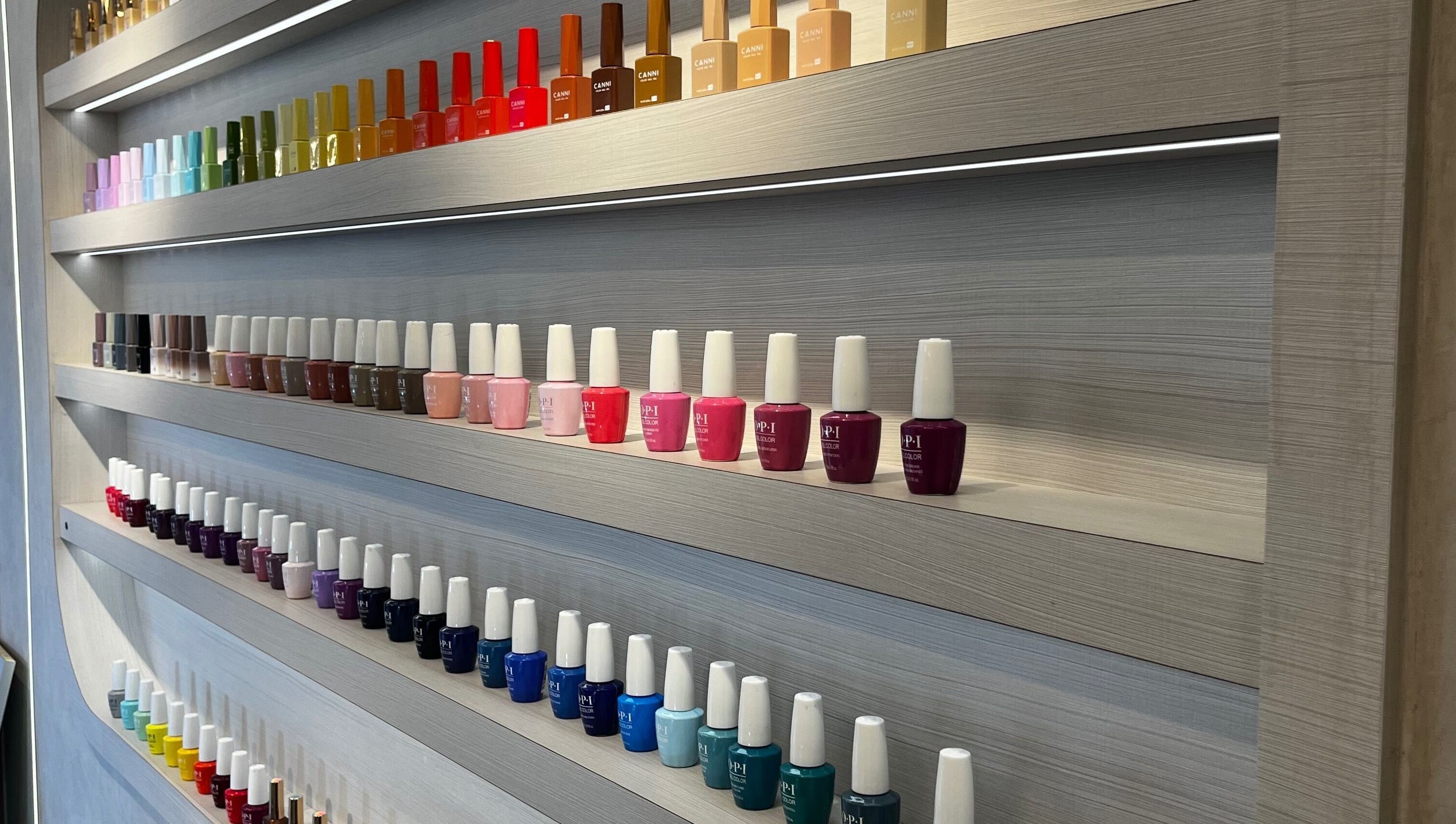 A vibrant nail polish display at Victoria Hair & Spa, Caracas, Miranda, VE, showcasing a rainbow of colors.