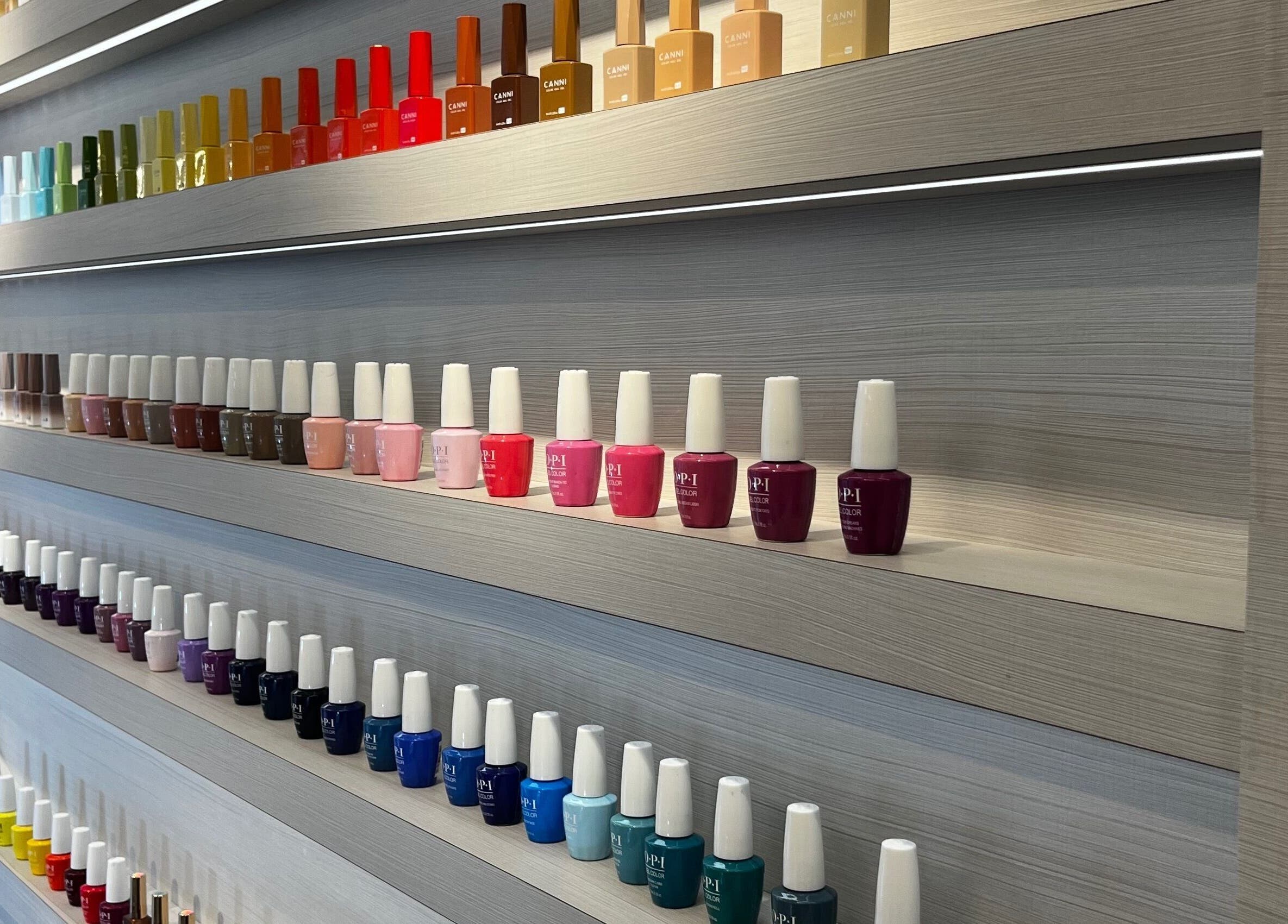 A vibrant nail polish display at Victoria Hair & Spa, Caracas, Miranda, VE, showcasing a rainbow of colors.