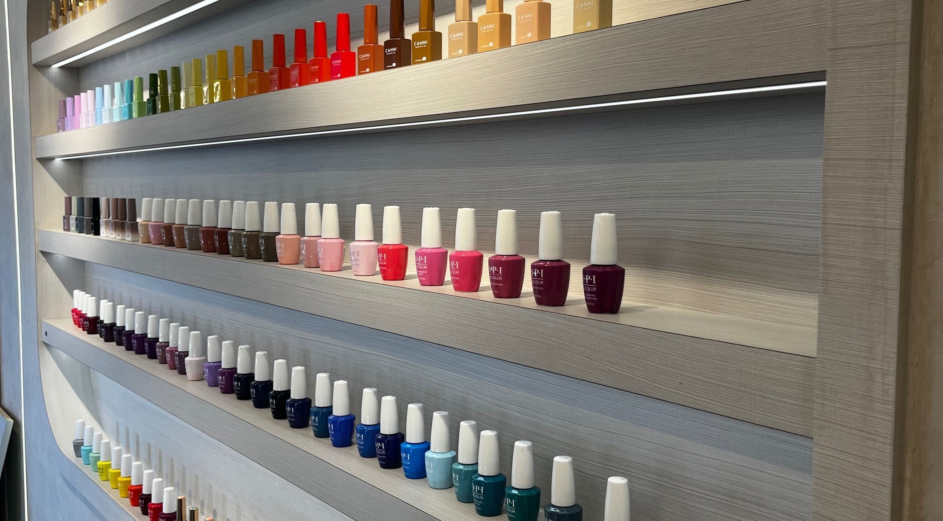 A vibrant nail polish display at Victoria Hair & Spa, Caracas, Miranda, VE, showcasing a rainbow of colors.