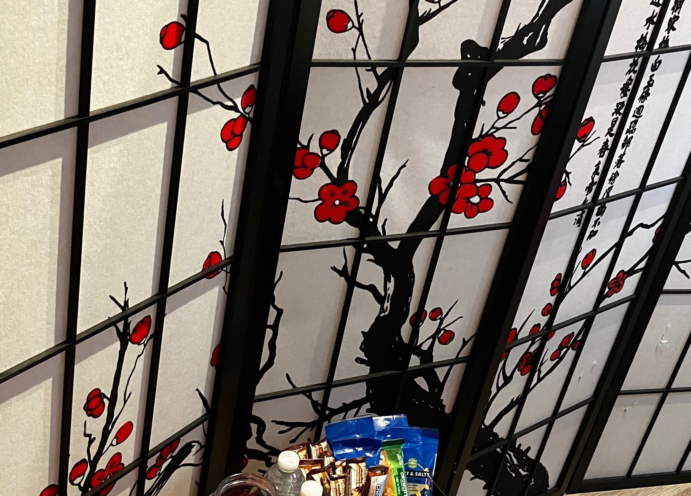 Elegant cherry blossom screen at B’LuxRoseLashesllc, Orlando, Florida, US, enhancing the wellness ambiance.