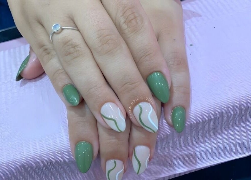 Stylish green manicure with wave design at Glow Nail Studio, Cape Town, Western Cape, ZA.