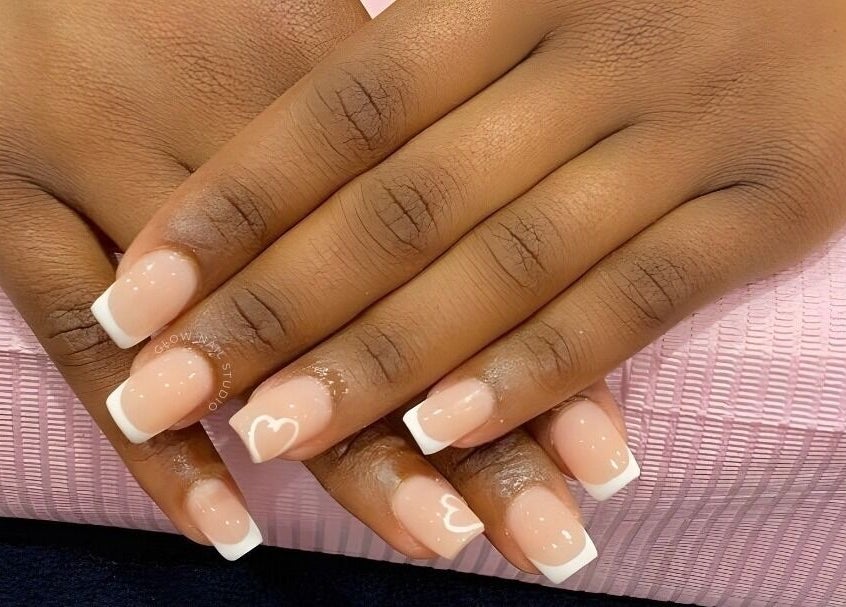 Elegant French manicure with heart design at Glow Nail Studio, Cape Town, Western Cape, ZA.