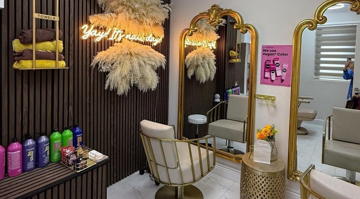 Chic beauty station at Sculpted by Jo in Stourbridge, England, GB, featuring gold mirrors and premium products.