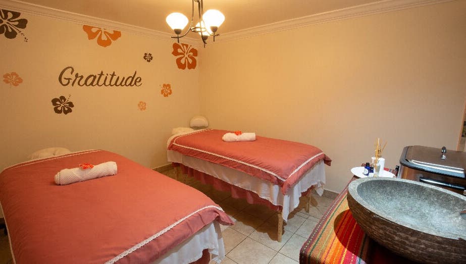 Serene massage room at NECTAR Spa OBBR, Oyster Bay, SX with soft lighting and cozy decor.