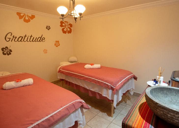Serene massage room at NECTAR Spa OBBR, Oyster Bay, SX with soft lighting and cozy decor.