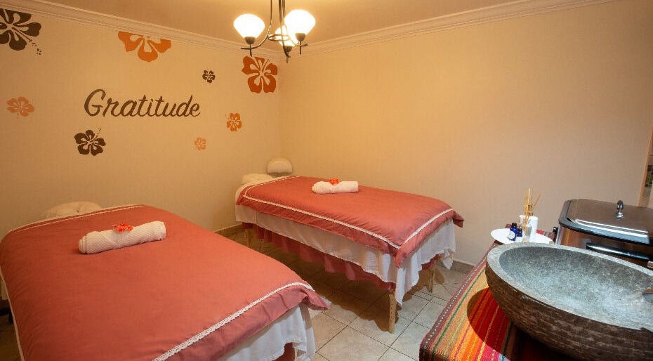 Serene massage room at NECTAR Spa OBBR, Oyster Bay, SX with soft lighting and cozy decor.