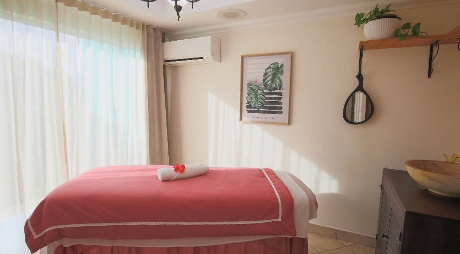 Tranquil massage room at NECTAR Spa OBBR, Oyster Bay, SX with pink linen and elegant decor.