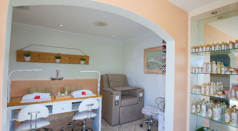 Relaxing manicure and pedicure area at NECTAR Spa OBBR, Oyster Bay, SX with plush seating and products.